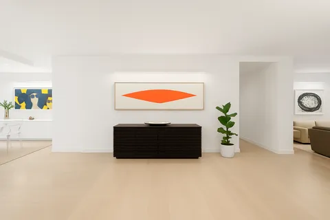 a room with a bed and a painting on the wall