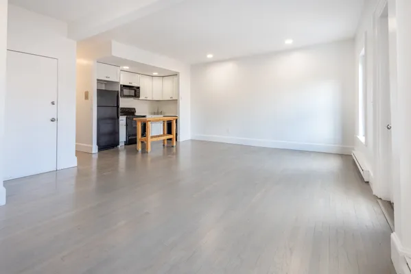 a view of kitchen with furniture and refrigerator