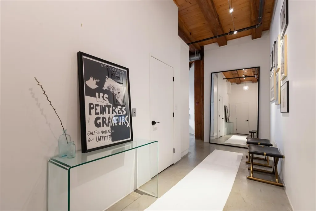 a view of a hallway with paintings on the wall