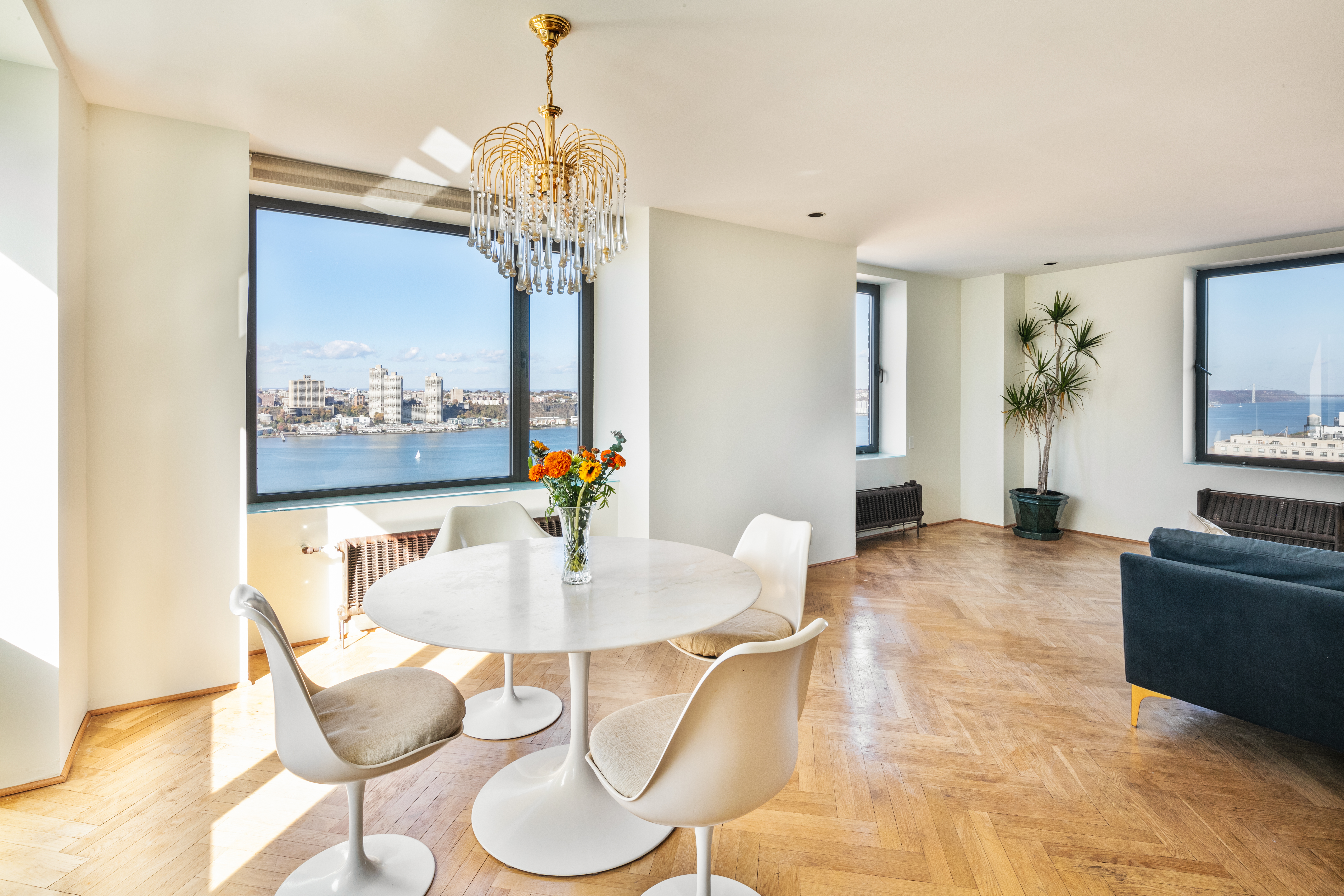 263 West End Avenue, Unit PH22B Manhattan, NY 10023 - Photo 9 of 19 a view of a dining room with furniture a chandelier and wooden floor
