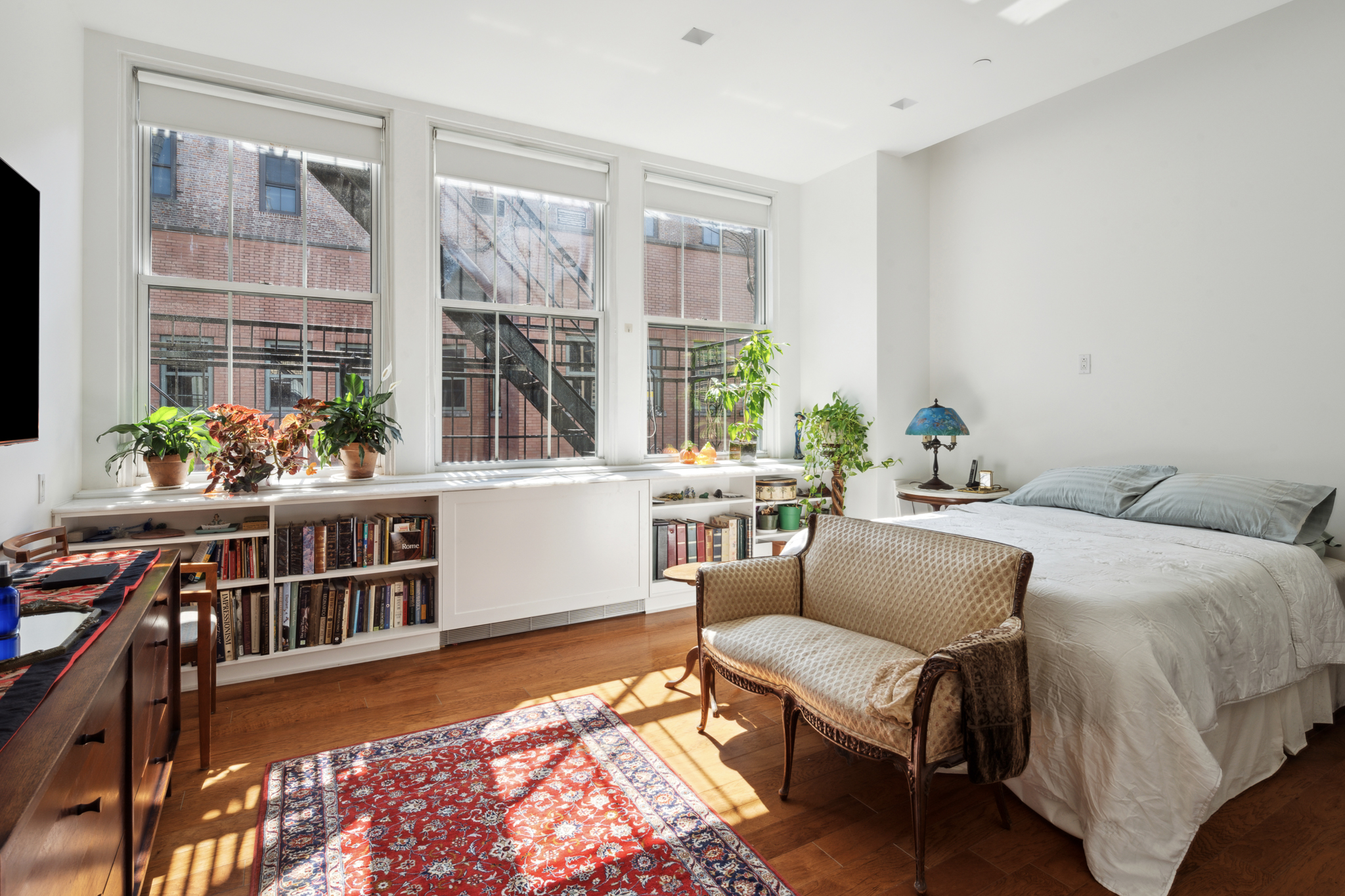 561 Broadway, Unit 10C Manhattan, NY 10012 - Photo 7 of 11 a living room with furniture and a window