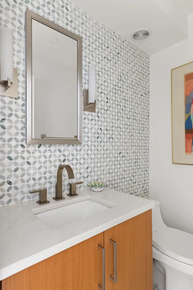 a bathroom with a sink a toilet and mirror