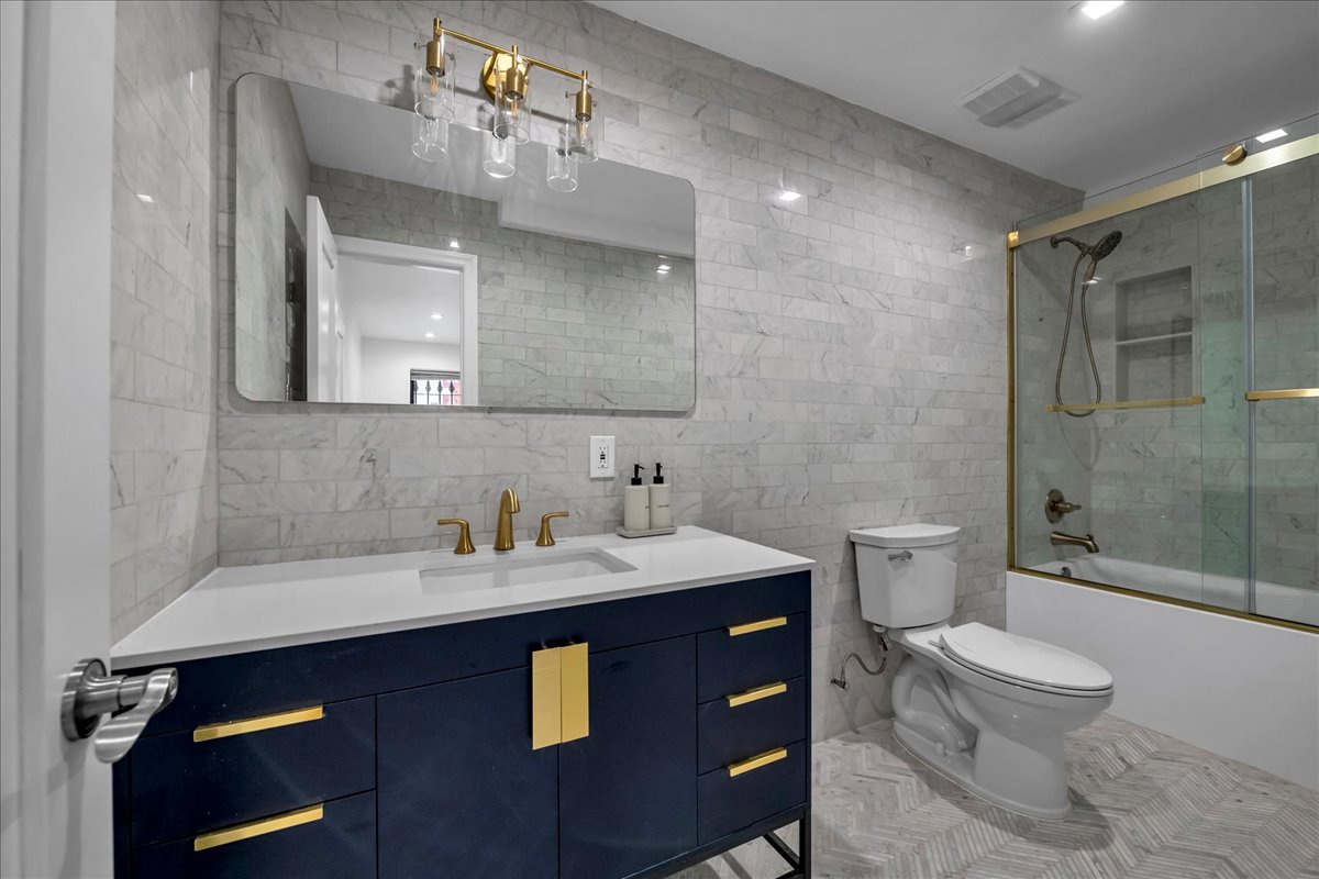 448 Halsey Street, Unit 1 Brooklyn, NY 11233 - Photo 16 of 22 a bathroom with a sink a toilet and shower