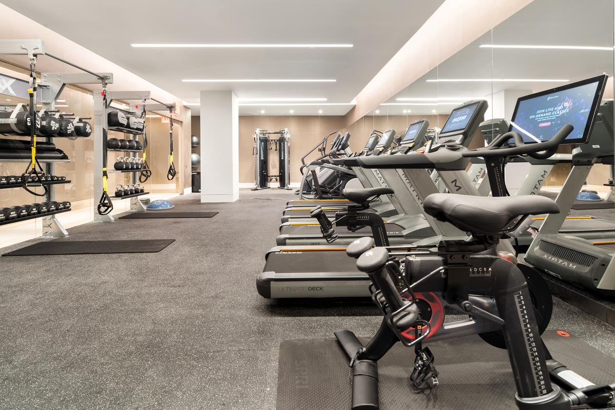49 Chambers Street, Unit 15B Manhattan, NY 10007 - Photo 14 of 20 a room with gym equipment and air hockey table