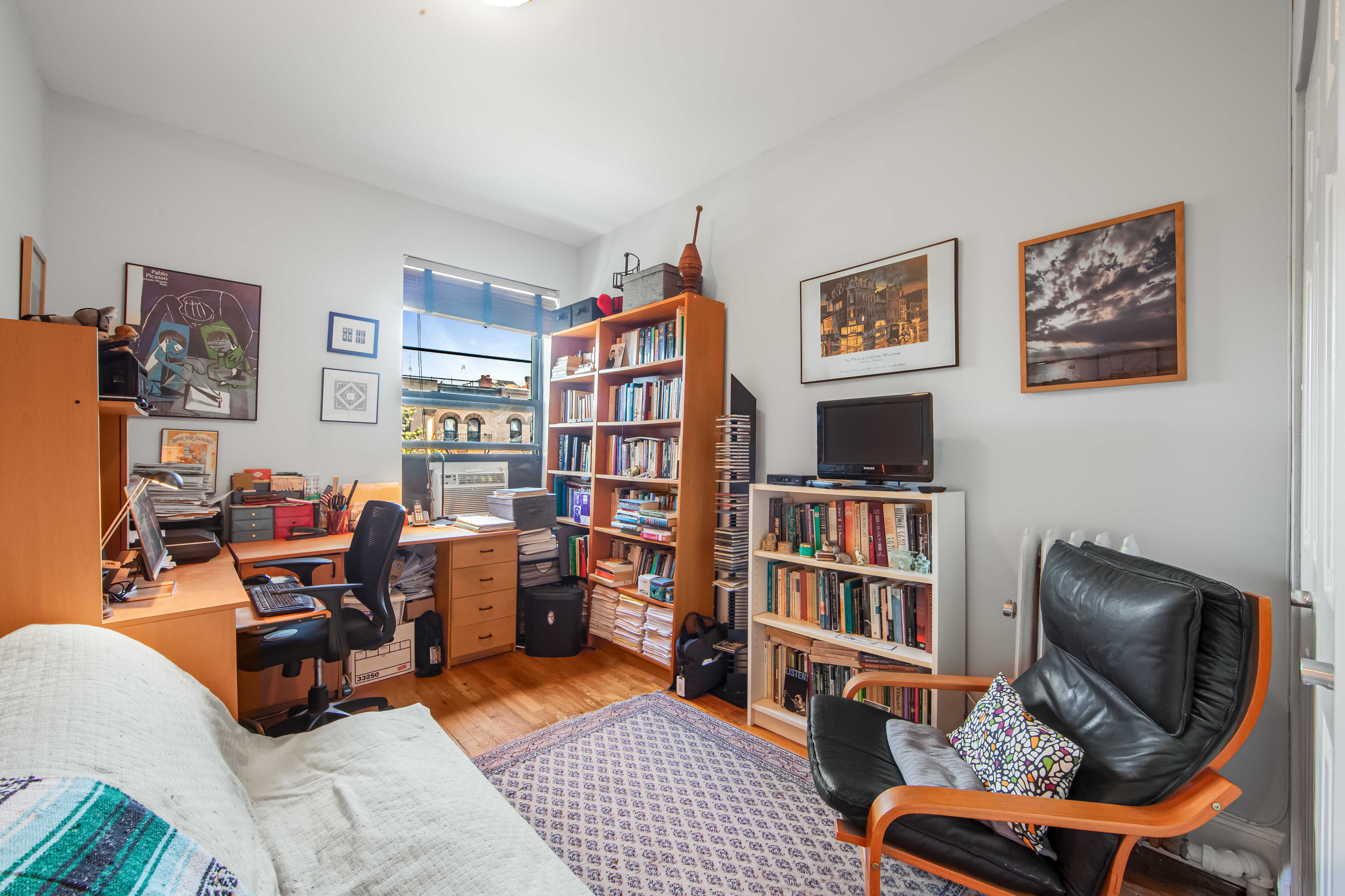 254 Park Place, Unit 4B Brooklyn, NY 11238 - Photo 8 of 12 a room with furniture workspace and book shelf
