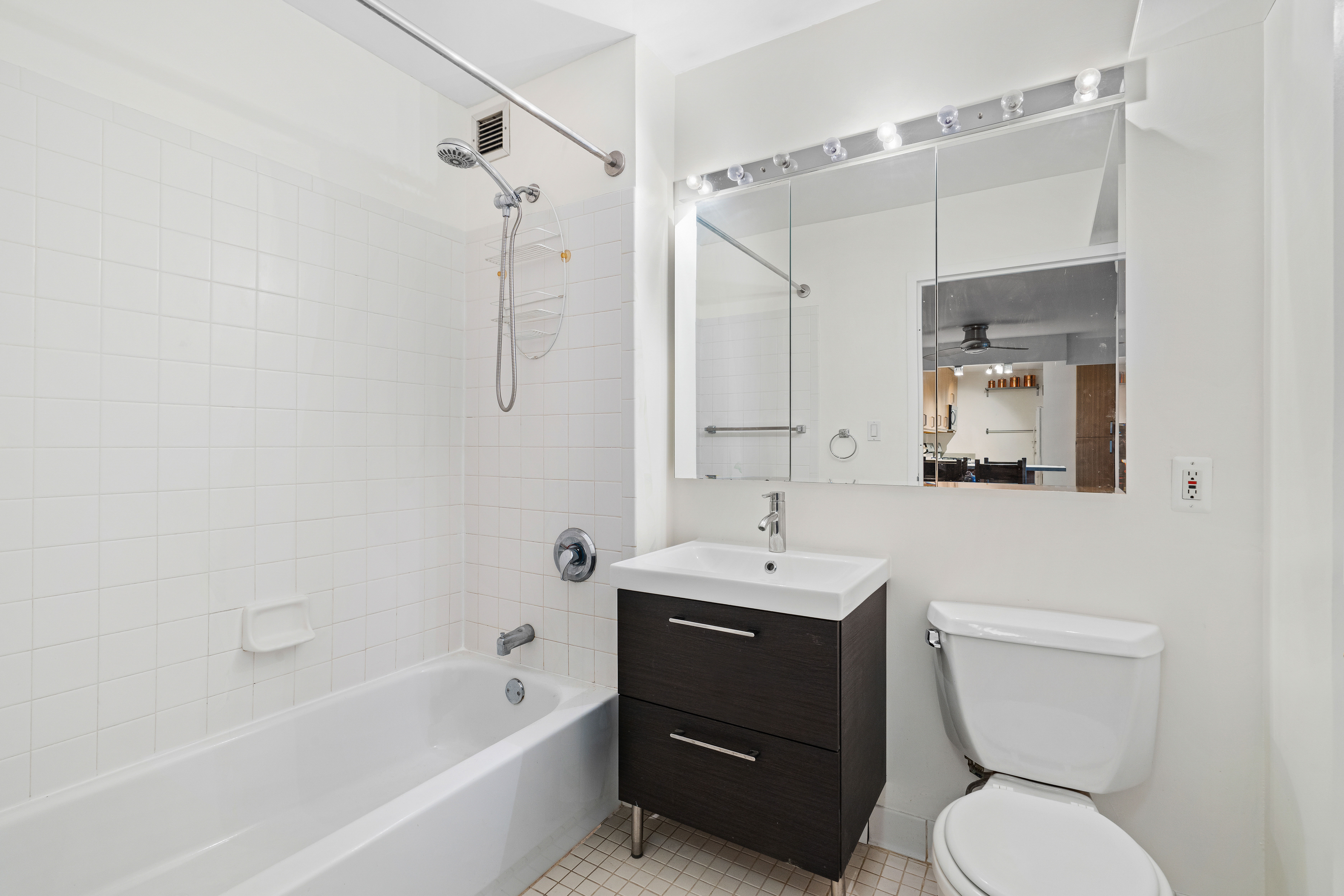 130 Lenox Avenue, Unit 522 Manhattan, NY 10026 - Photo 6 of 7 a bathroom with a toilet sink shower and mirror