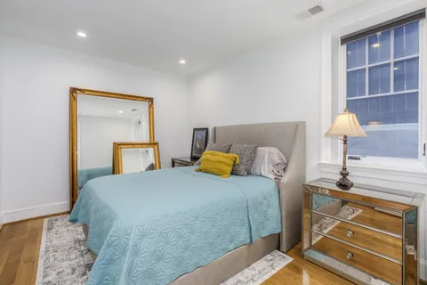 a bedroom with a bed and a lamp