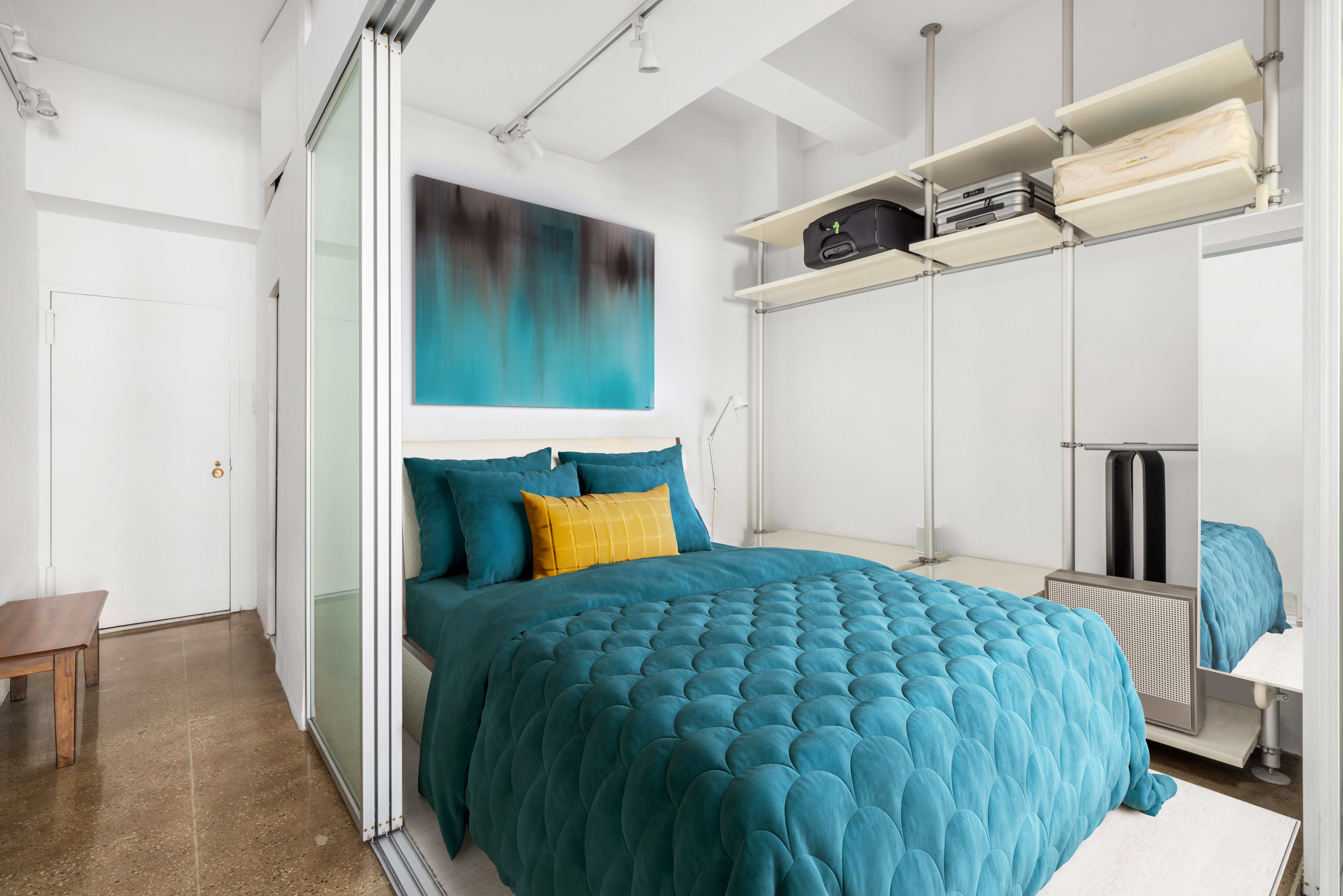 315 7th Avenue, Unit 6C Manhattan, NY 10001 - Photo 7 of 10 a bedroom with a bed and a cabinets