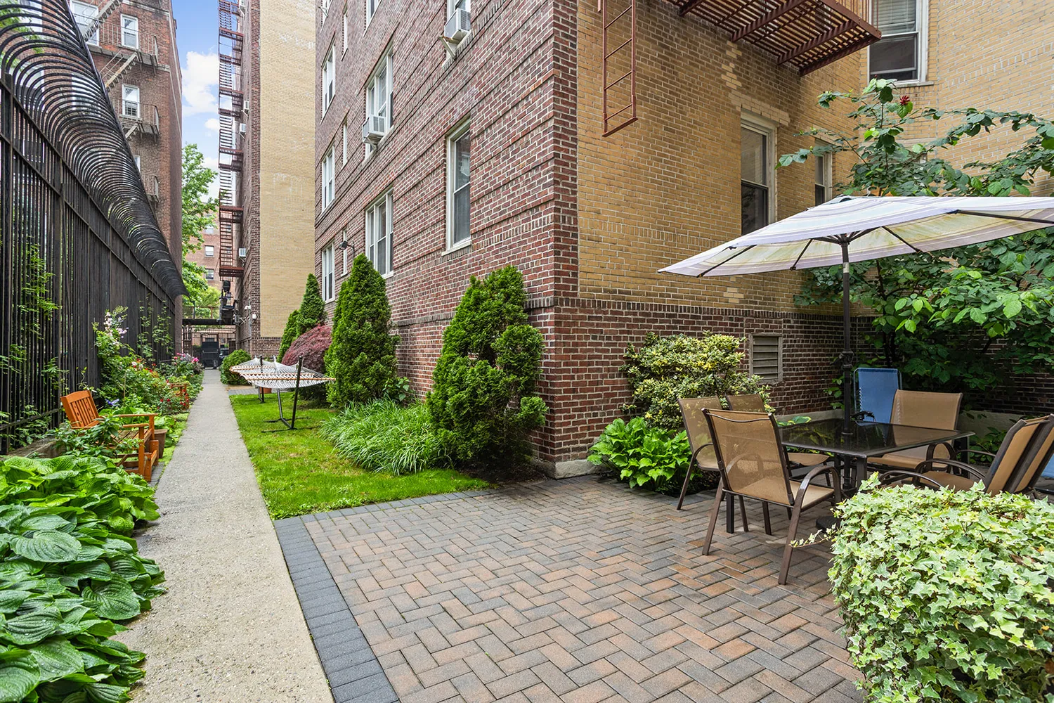 a view of a patio with table and chairs under an umbrella