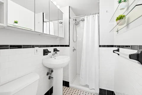a bathroom with a sink a mirror and shower