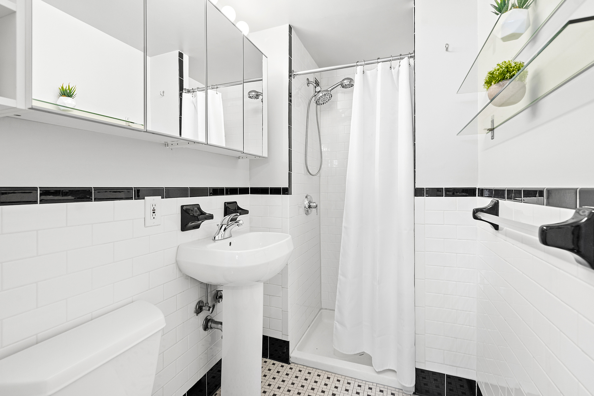 1831 Madison Avenue, Unit 9E Manhattan, NY 10035 - Photo 10 of 18 a bathroom with a sink a mirror and shower