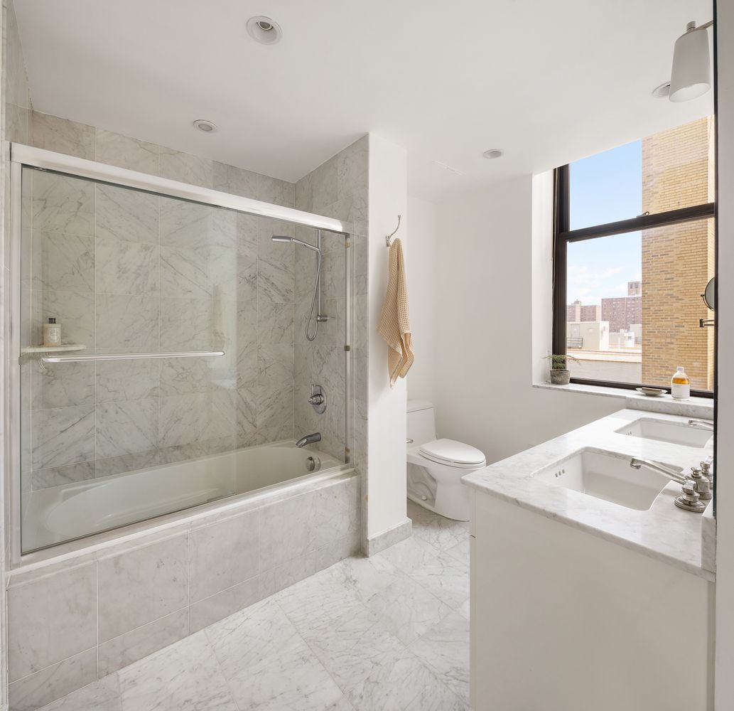1255 5th Avenue, Unit 6D Manhattan, NY 10029 - Photo 5 of 15 a bath room with a bath tub and a shower
