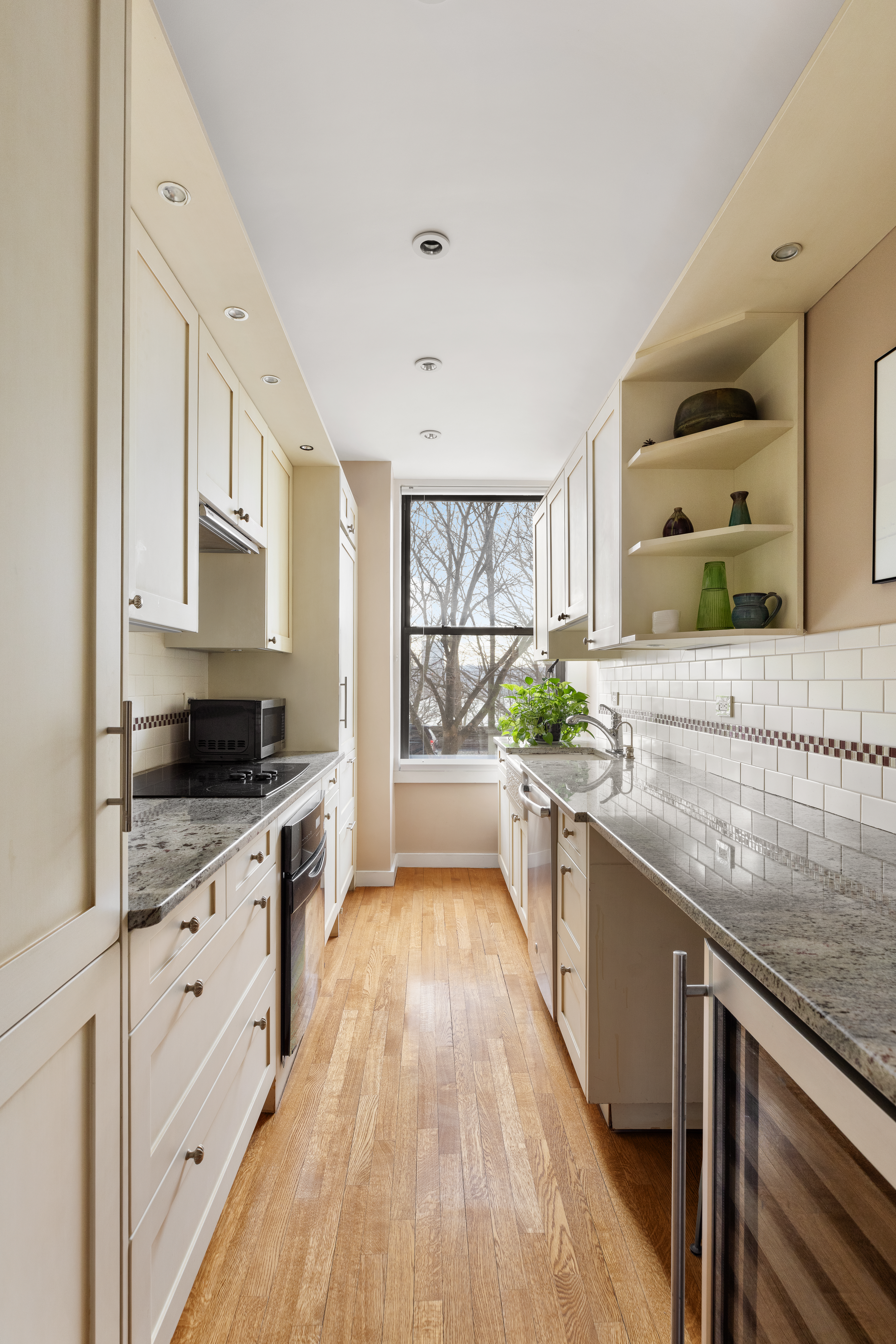 137 Riverside Drive, Unit 2D Manhattan, NY 10024 - Photo 15 of 20 a large kitchen with stainless steel appliances granite countertop a lot of counter space and wooden floors