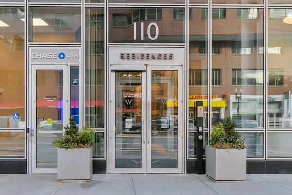 a front view of a building with a potted plant