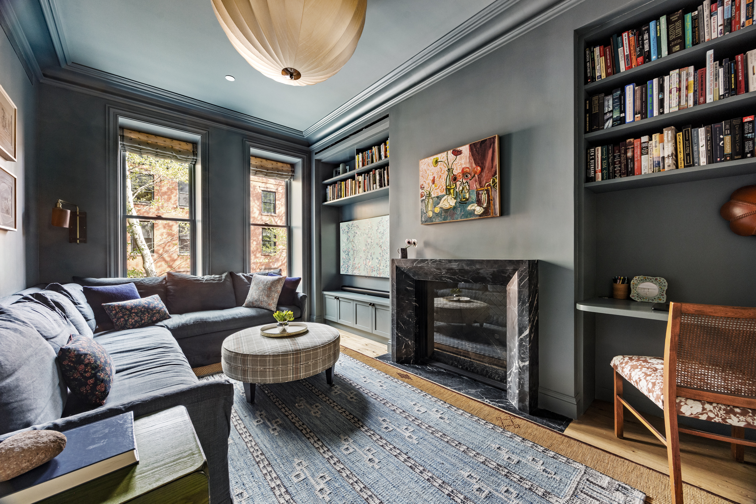 40 Garden Place Brooklyn, NY 11201 - Photo 16 of 33 a living room with furniture a fireplace and a book shelf