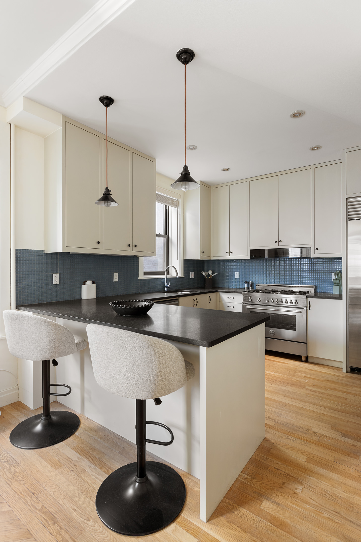 1845 Adam Clayton Powell Jr Boulevard, Unit 5C Manhattan, NY 10026 - Photo 7 of 17 a kitchen with stainless steel appliances granite countertop a sink a stove and a wooden floors