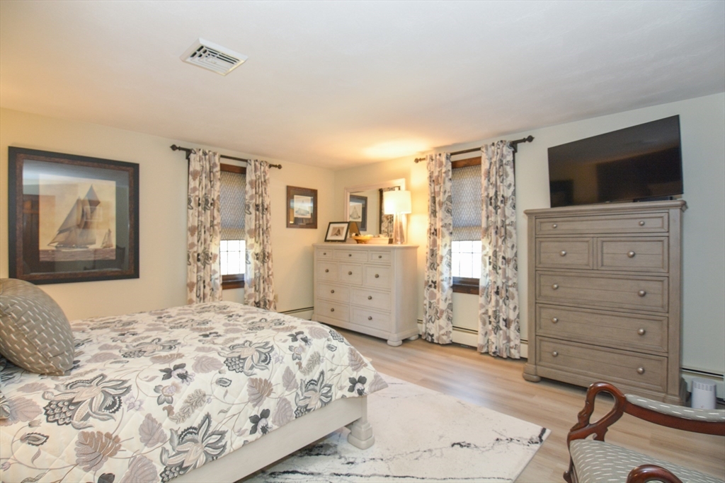 187 Blackstone Street Mendon, MA 01756 - Photo 21 of 42 a bedroom with a large bed and a flat tv screen on dresser