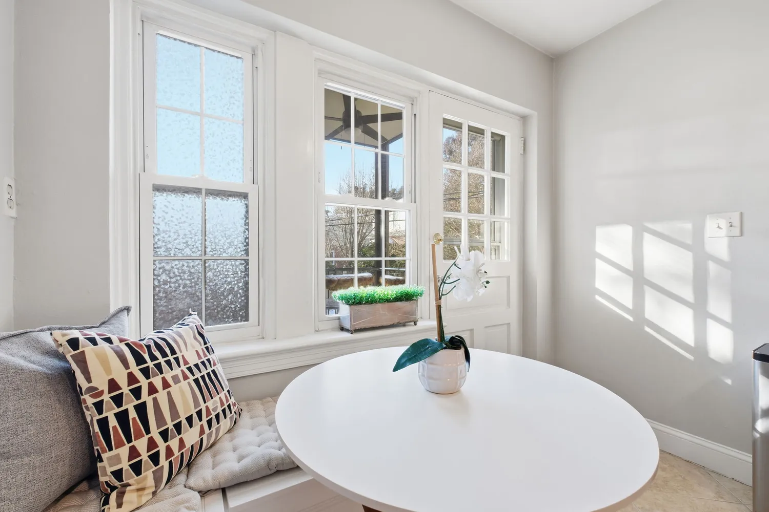 a living room with furniture and large windows