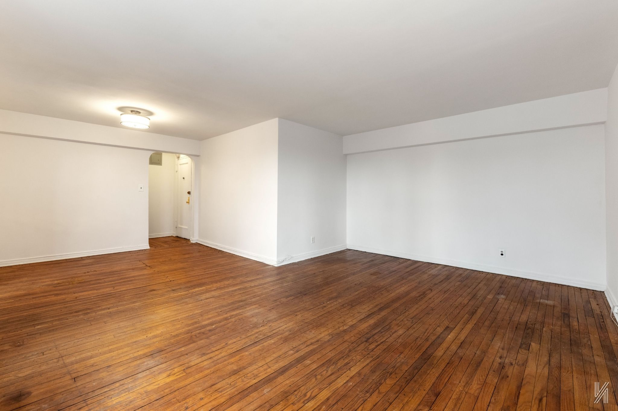 22-60 79th Street, Unit 3E Queens, NY 11370 - Photo 3 of 17 a view of empty room with wooden floor