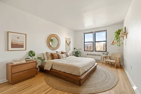 a living room with a bed furniture and a window