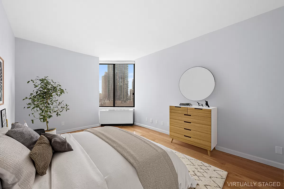 300 East 93rd Street, Unit 14F Manhattan, NY 10128 - Photo 6 of 14 a bedroom with a bed and a window