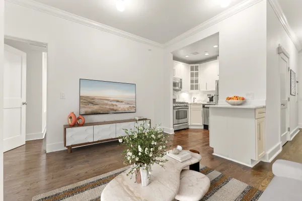 a living room with furniture and wooden floor