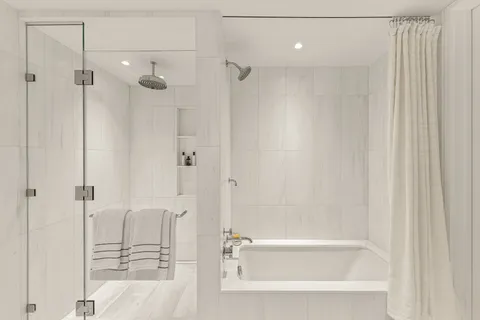 a bathroom with a bathtub and a shower