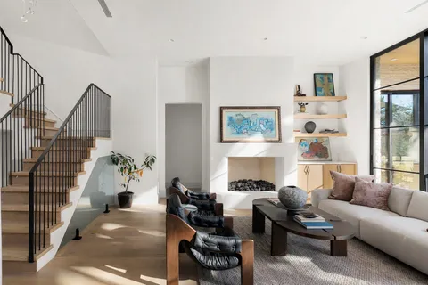 a living room with furniture and large windows