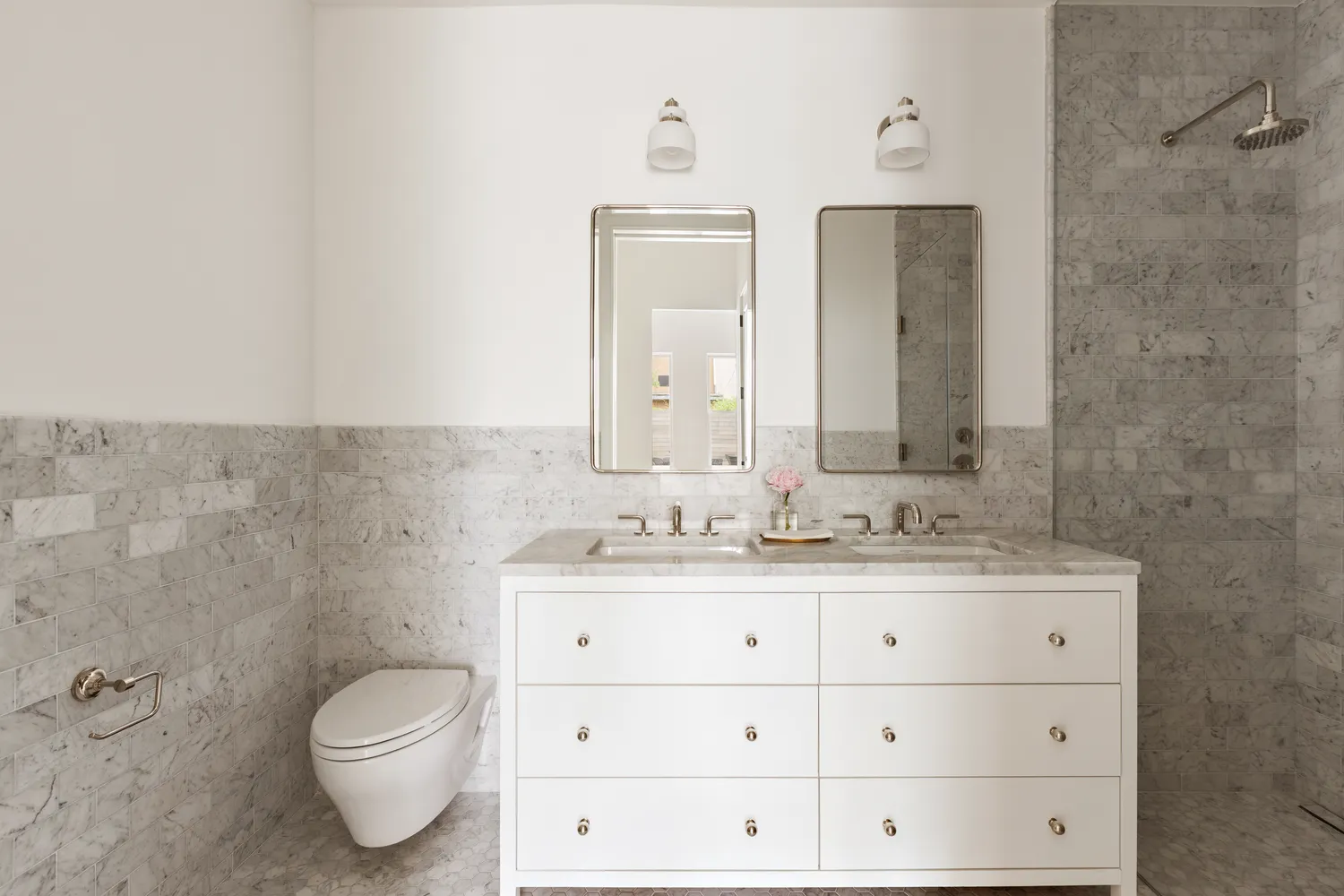 a bathroom with a granite countertop toilet sink and mirror