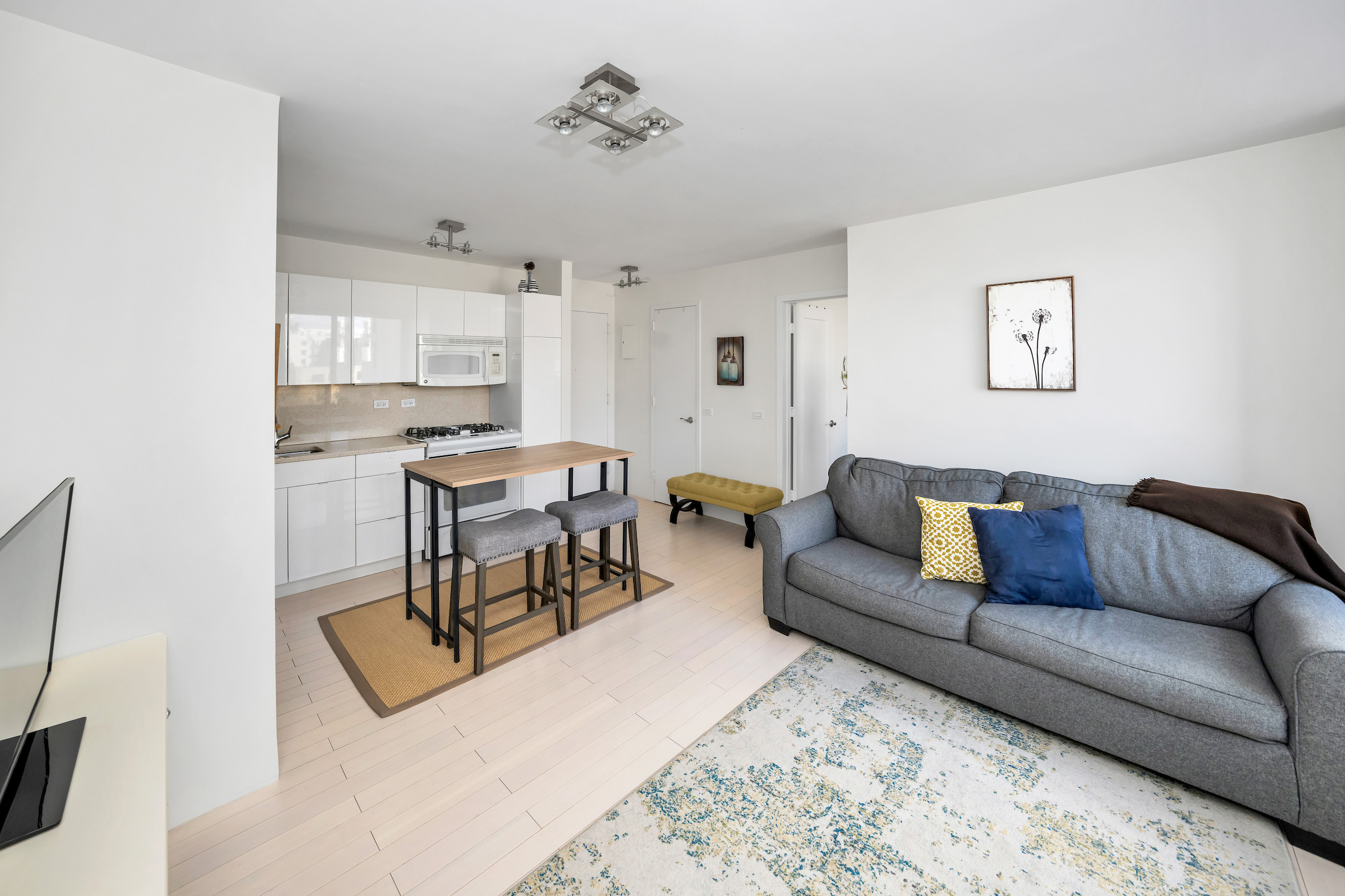 2373 Broadway, Unit 1425 Manhattan, NY 10024 - Photo 4 of 13 a living room with furniture a view and a window