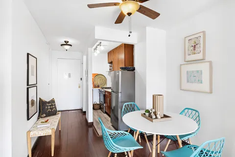 a kitchen with stainless steel appliances granite countertop a sink a stove and a wooden floors