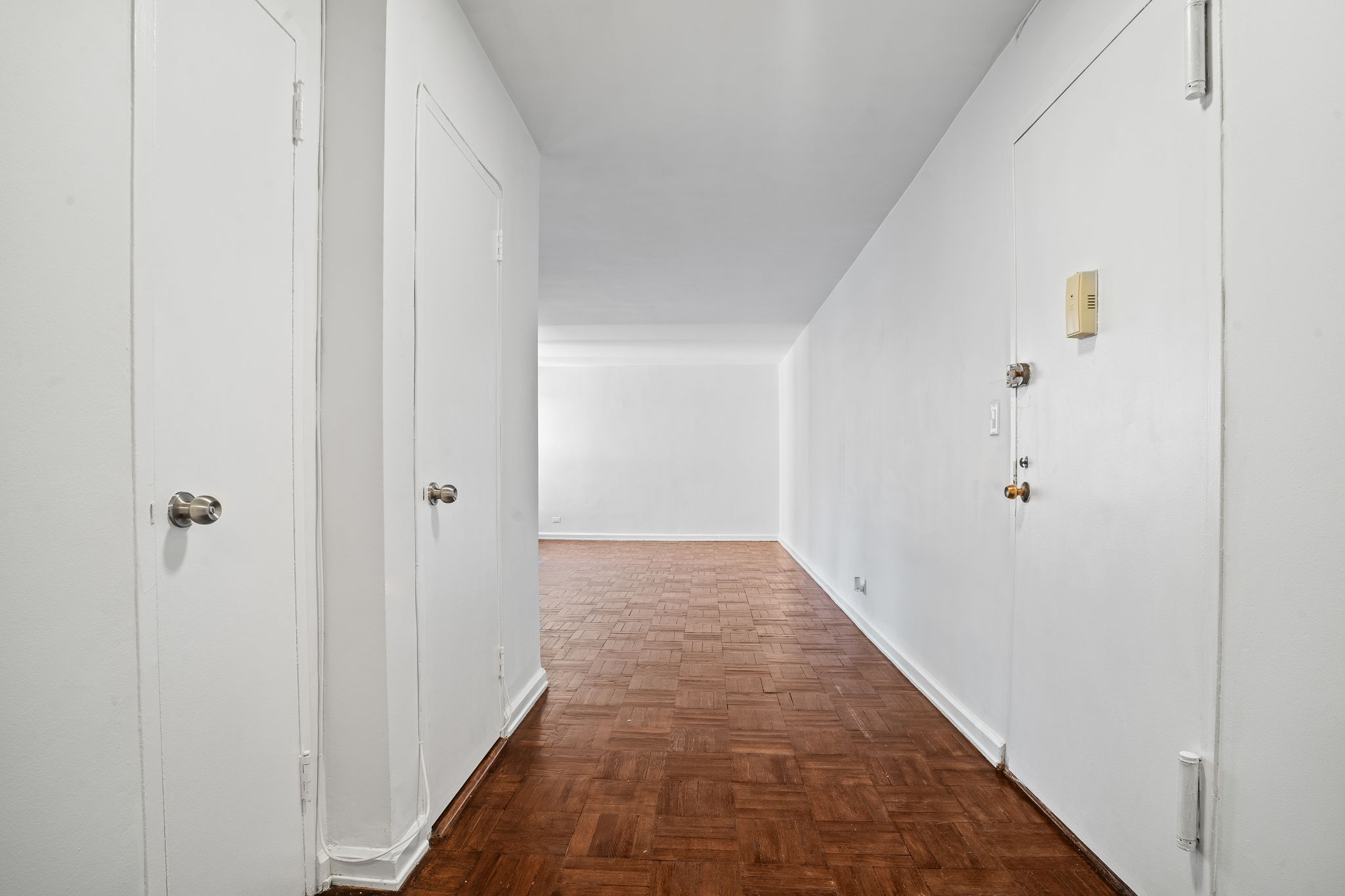 150 East 61st Street, Unit 8B Manhattan, NY 10065 - Photo 18 of 30 a view of a hallway with wooden floor
