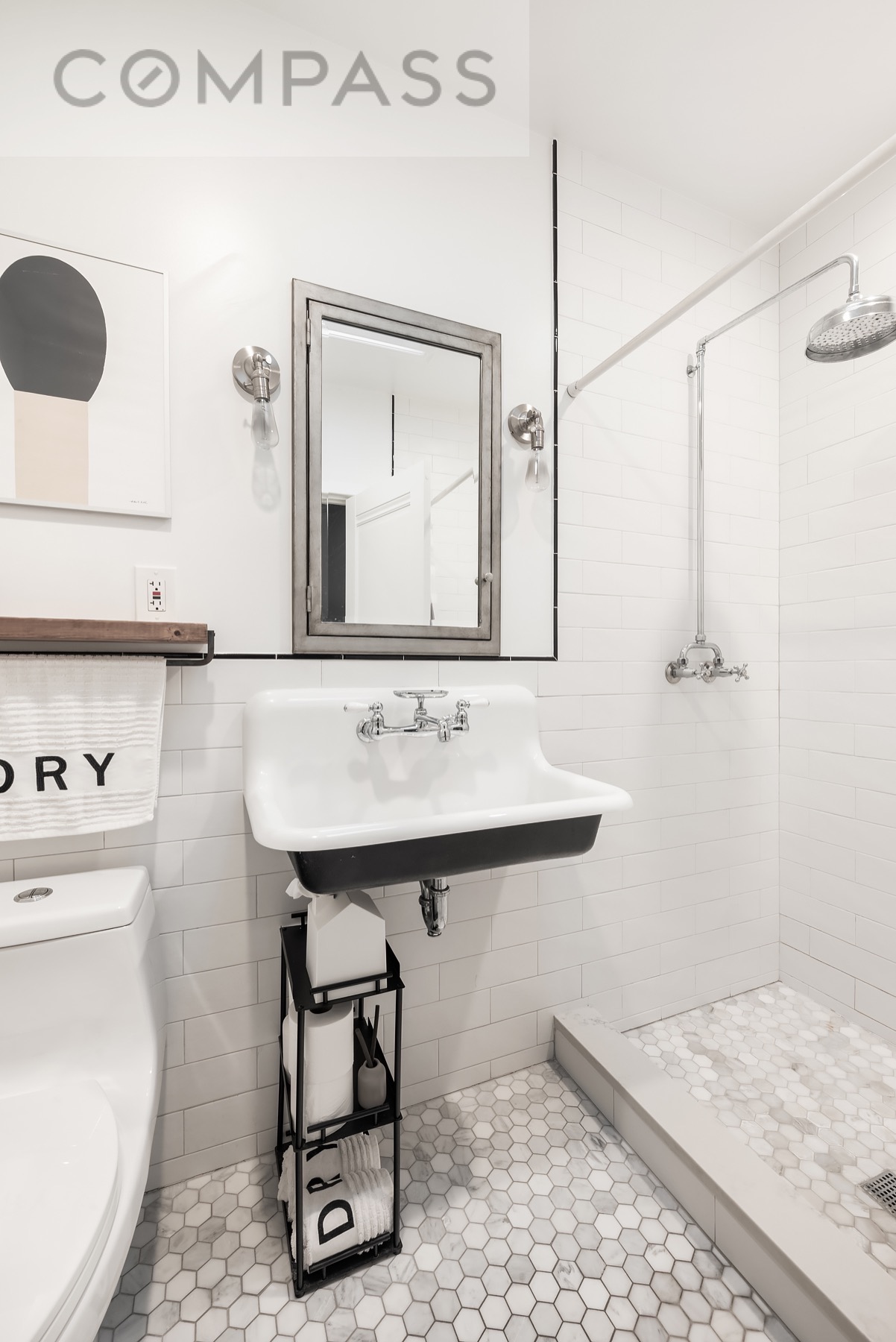 69 Sterling Street Brooklyn, NY 11225 - Photo 5 of 14 a bathroom with a sink a toilet and mirror