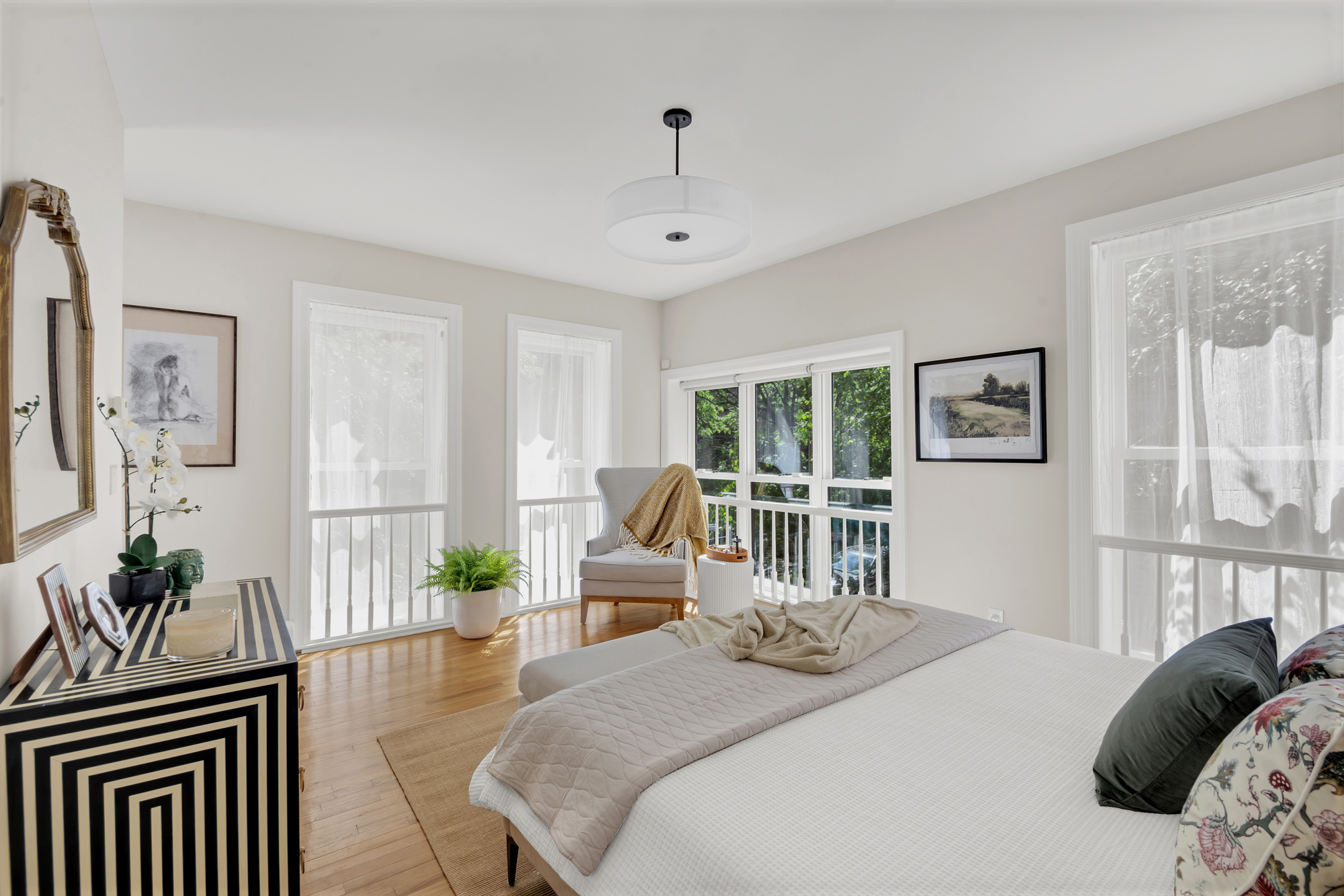 1 Mount Morris Park West, Unit 1A Manhattan, NY 10027 - Photo 7 of 12 a bedroom with a bed wooden floor and a large window