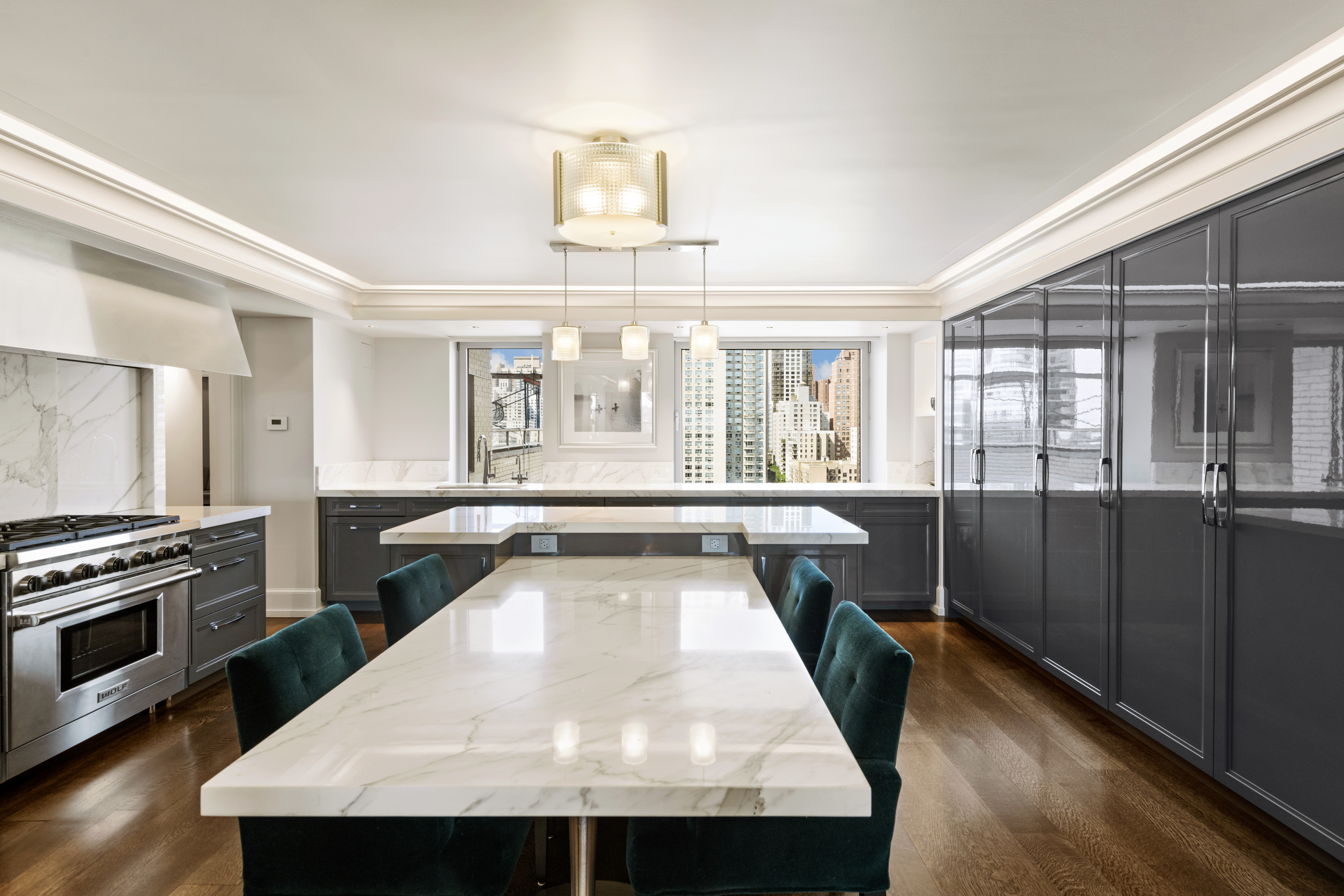 180 East End Avenue, Unit 15E Manhattan, NY 10128 - Photo 6 of 31 a view of a kitchen with a stove wooden cabinets and a refrigerator
