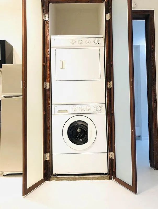 112 West 15th Street, Unit 2 Manhattan, NY 10011 - Photo 5 of 13 a utility room with dryer and washer