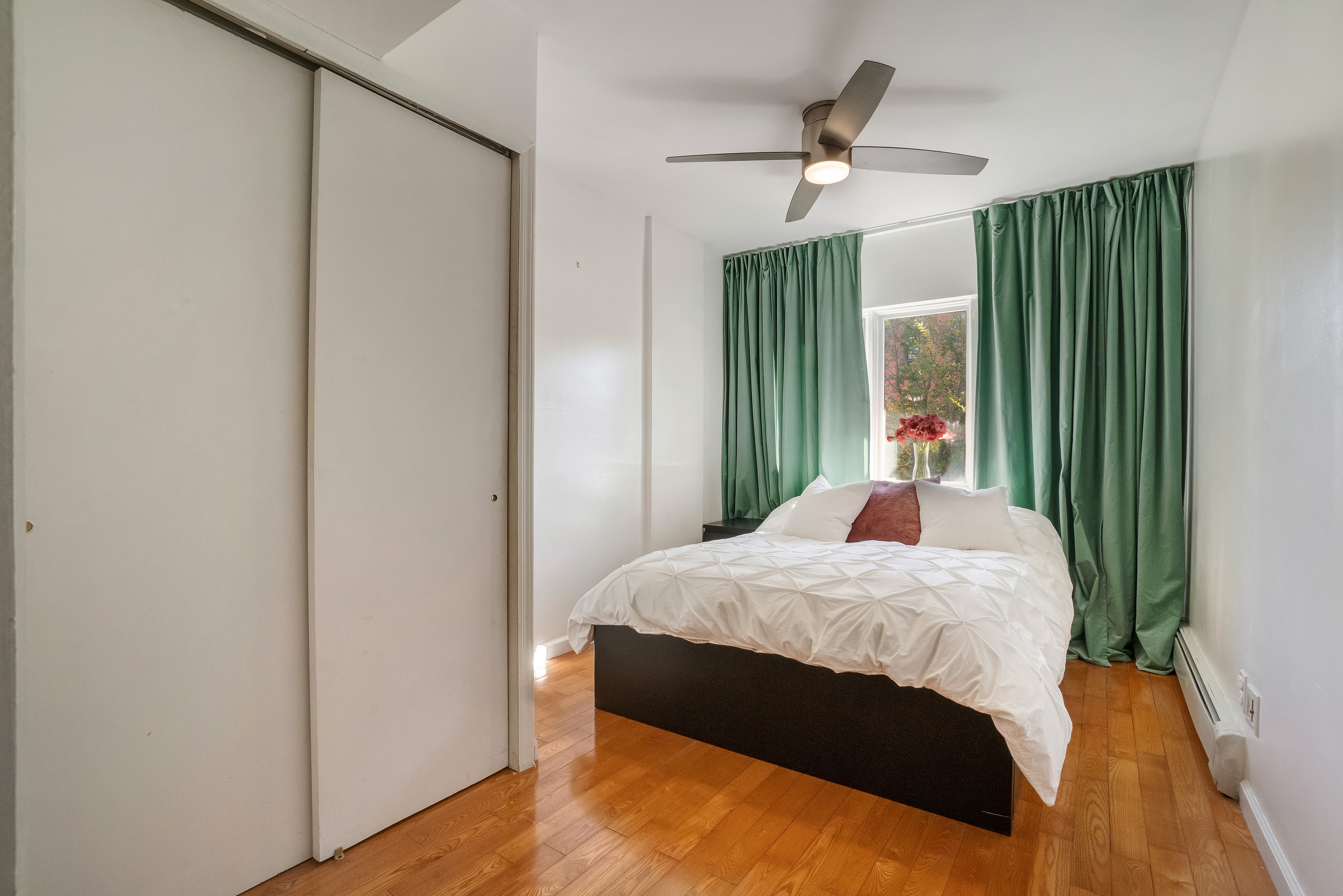 1570 Prospect Place, Unit 3 Brooklyn, NY 11233 - Photo 6 of 10 a bed sitting in a bedroom next to a window