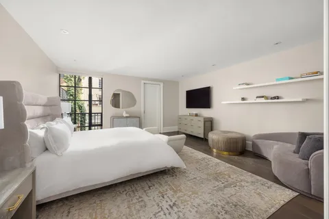 a spacious bathroom with a bathtub sink and mirror