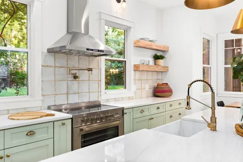 a kitchen with a stove a sink and a cabinets