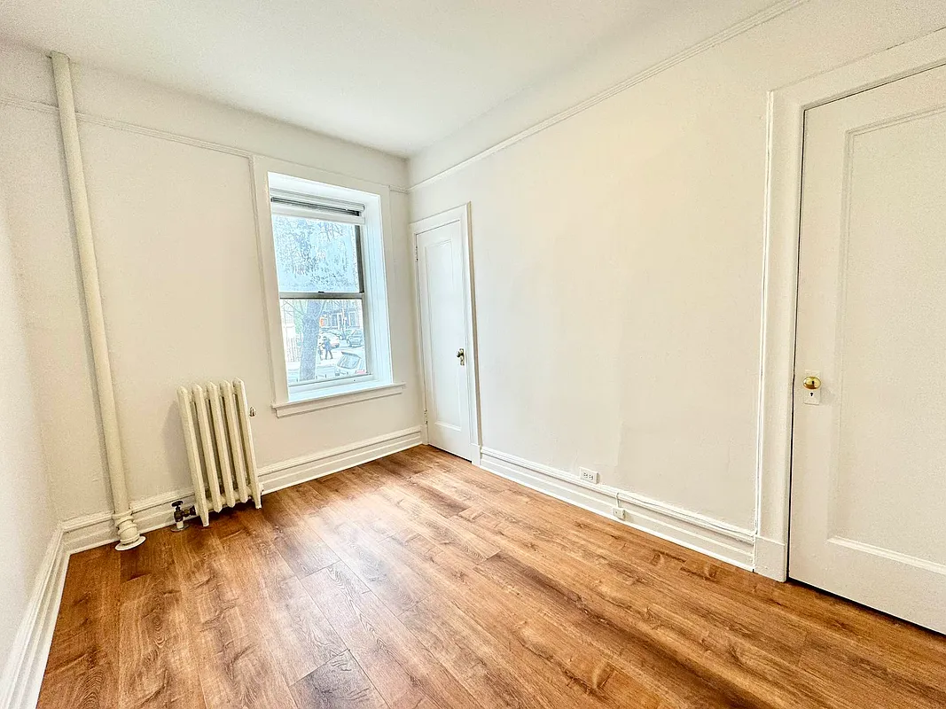 2022 Beverley Road, Unit 3 Brooklyn, NY 11226 - Photo 10 of 11 an empty room with wooden floor and windows