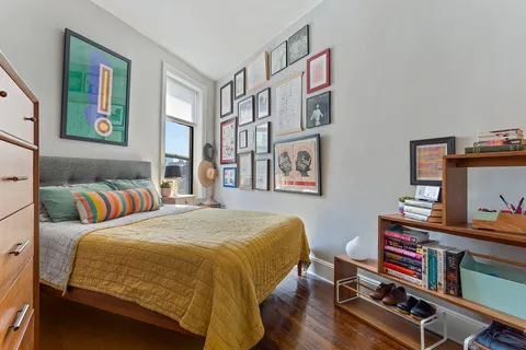 a bedroom with a bed and a bookshelf