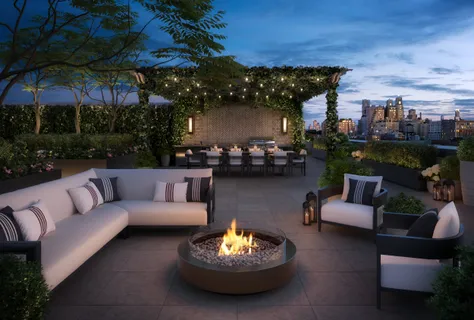 a view of a patio with couches and a fire pit and a fire pit with the couches near an umbrella