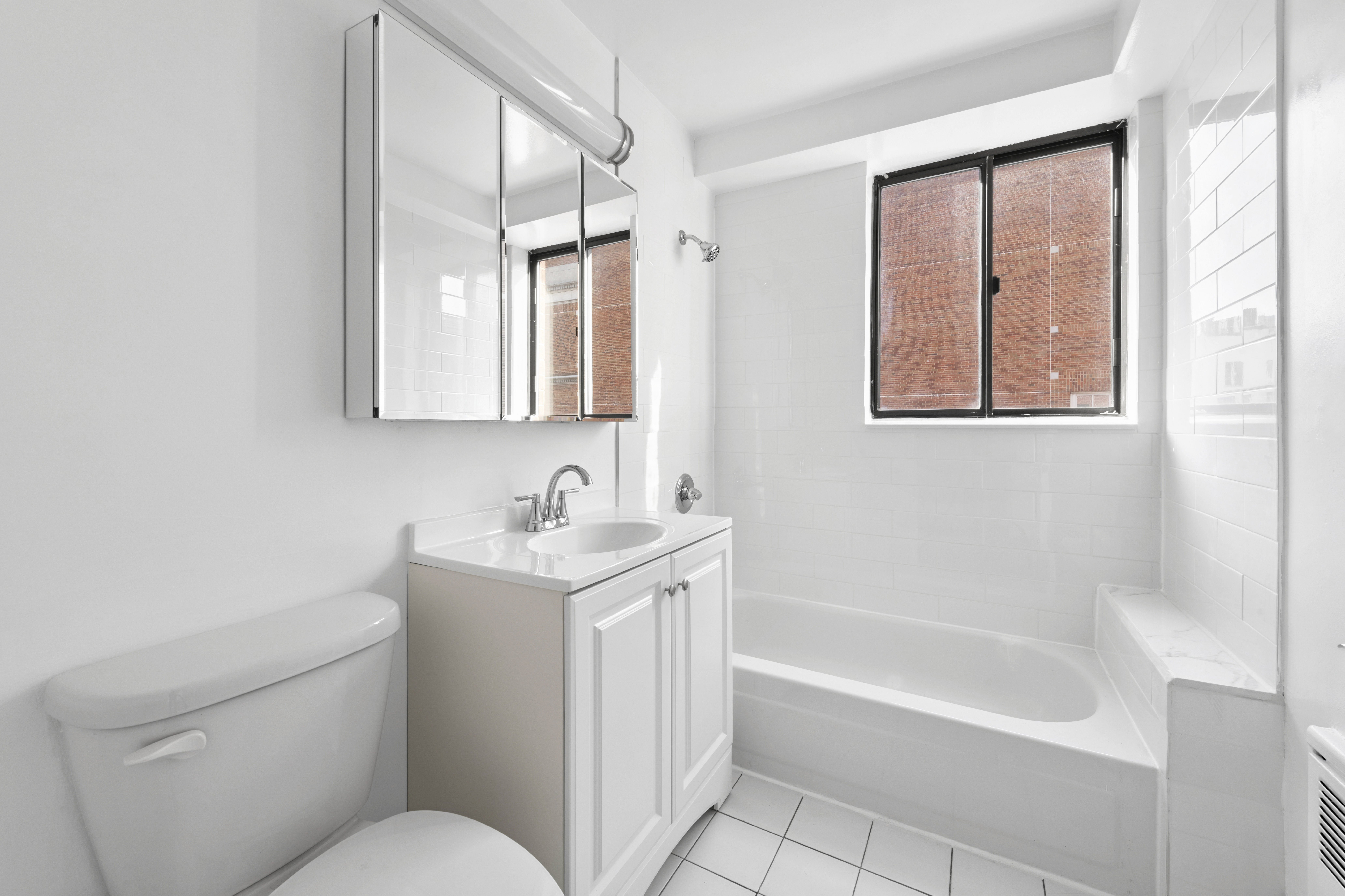 179 Grand Street, Unit 6G Manhattan, NY 10013 - Photo 7 of 8 a bathroom with a toilet sink and mirror
