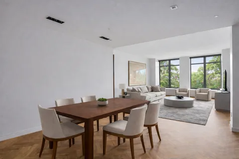 a view of a dining room with furniture and a large window