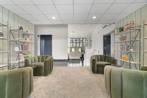 a living room with furniture a ceiling fan and a rug