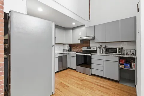 a kitchen with stainless steel appliances granite countertop a refrigerator and a sink