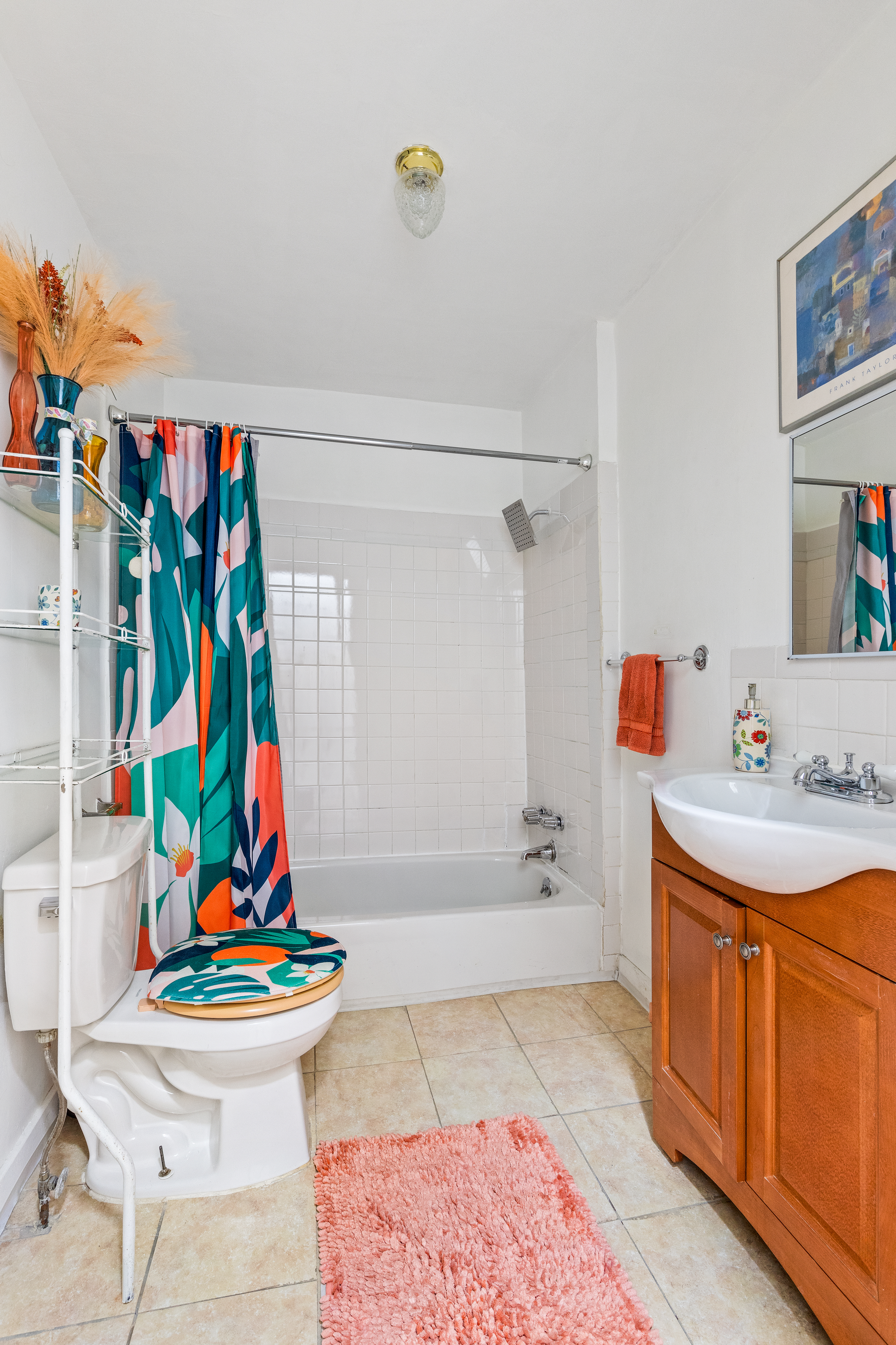 415 Monroe Street Brooklyn, NY 11221 - Photo 6 of 9 a bathroom with a sink a toilet and shower curtain