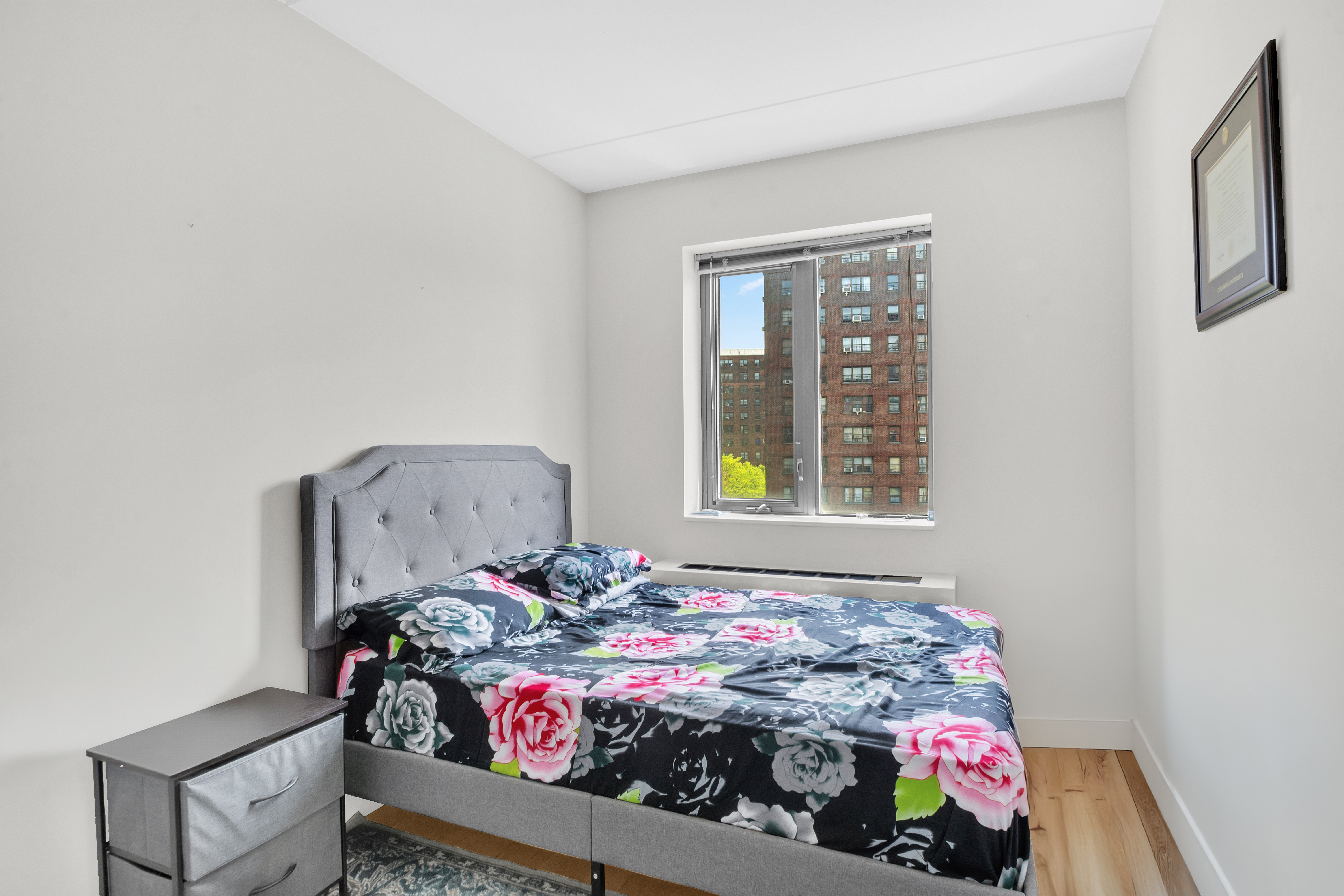 1810 3rd Avenue, Unit A7D Manhattan, NY 10029 - Photo 7 of 13 a bed sitting in a bedroom next to a window