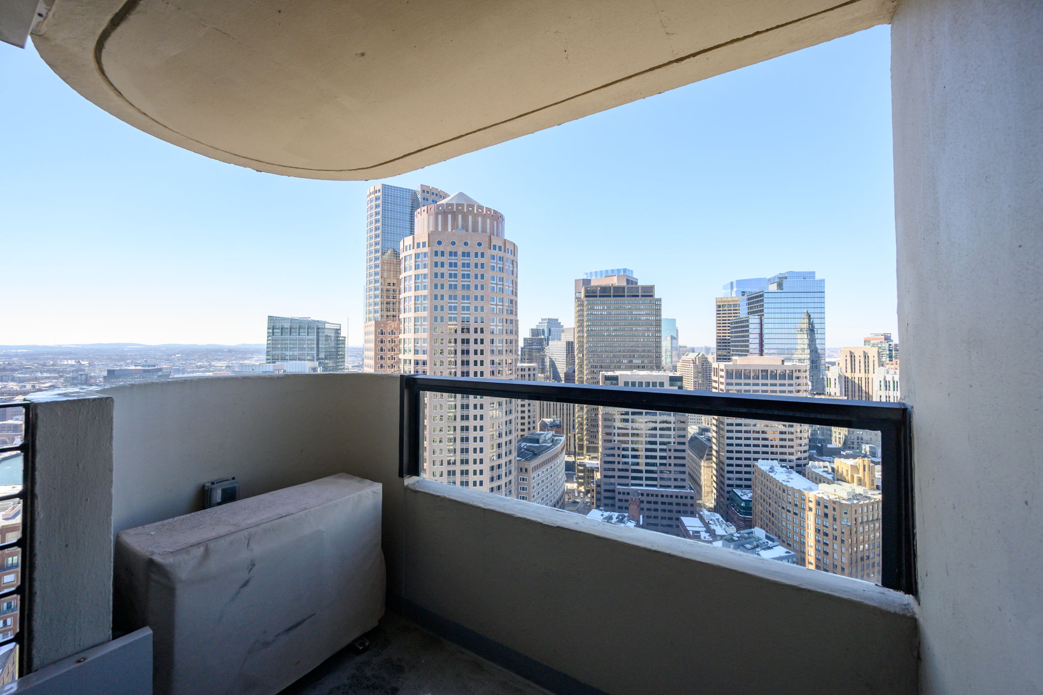 65 East India Row, Unit 38 F/G Boston, MA 02110 - Photo 26 of 32 a view of roof deck with two couches and wooden floor
