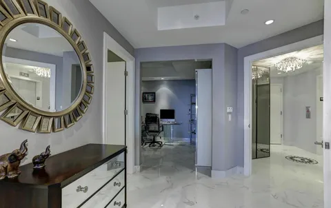 a view of a livingroom with furniture and mirror